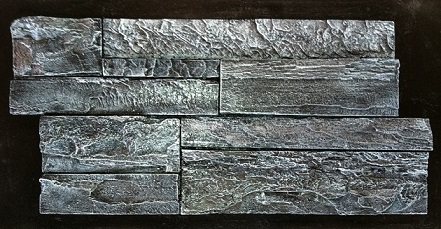 A concrete stacked stone backsplash panel coloured in dark charcoal and silver with a metallic sheen, photographed against a black background.