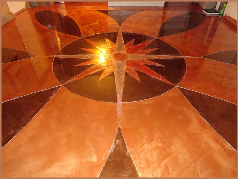A glossy concrete floor in copper and bronze tones with a large compass rose medallion cut and coloured into the centre.