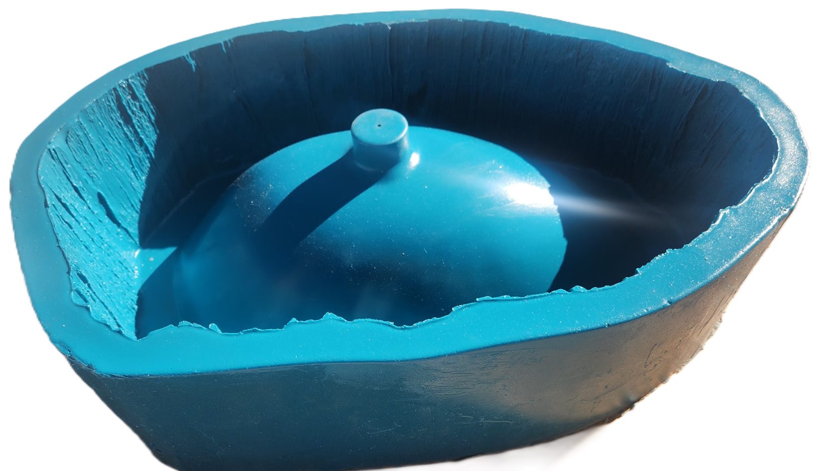 A blue silicone concrete sink mold showing the bark-textured outer shell and the domed inner plug.