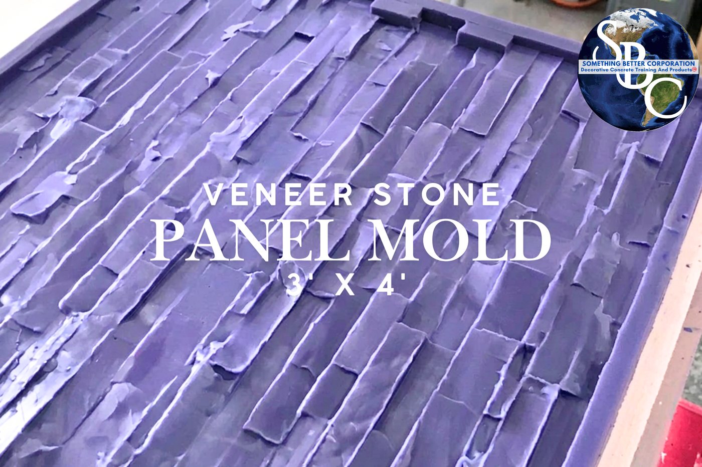 A large purple rubber panel mold showing the negative impression of stacked stone courses, photographed at an angle.