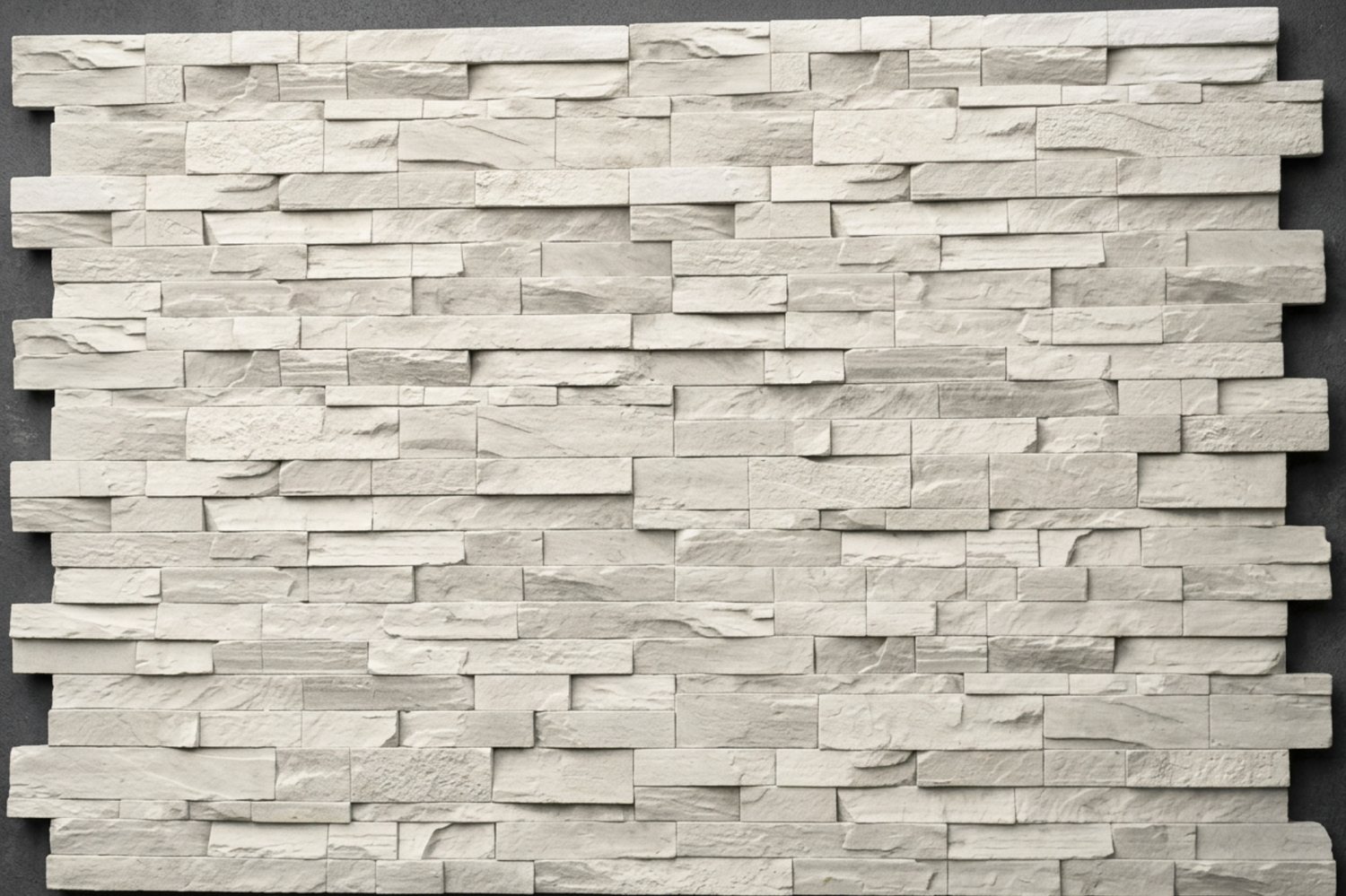A flat rectangular stone veneer panel in plain off-white, showing the moulded pattern of stacked rectangular stones with interlocking edges.