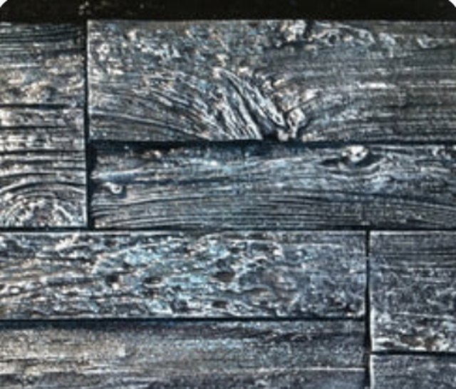 Concrete panel cast in the Best Barnwood pattern, showing weathered plank grain and knots.