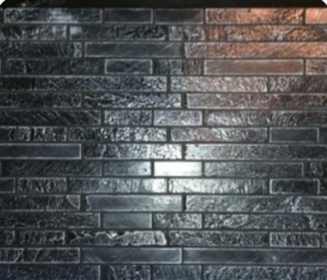 Concrete panel cast in the Micro Slate and Glass pattern, showing fine linear mosaic strips.