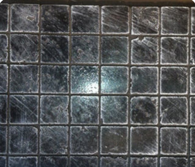 Concrete panel cast in the Best Travertine pattern, showing a grid of square tiles with a pitted face.